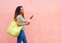 Cheerful woman with coffee texting outdoors Royalty Free Stock Photo