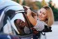Cheerful woman coming out window of her car Royalty Free Stock Photo