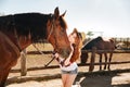 Cheerful woman cowgirl with her horse on ranch Royalty Free Stock Photo