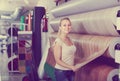 cheerful woman customer choosing linoleum flooring in hypermarket Royalty Free Stock Photo