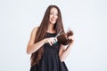 Cheerful woman cutting splitting ends of long hair with scissors Royalty Free Stock Photo