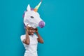 Cheerful woman in 3d papercraft in form of colorful unicorn