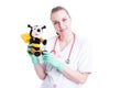 Cheerful woman doctor holding a bee plush toy