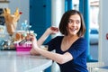 Cheerful woman drinking coffee latte and smiling sitting in cafe Royalty Free Stock Photo