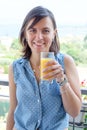 Cheerful woman drinking a glass of orange juice Royalty Free Stock Photo