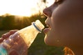 cheerful woman drinking water from a transparent bottle Royalty Free Stock Photo