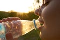 cheerful woman drinking water from a transparent bottle Royalty Free Stock Photo