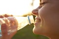 cheerful woman drinking water from a transparent bottle Royalty Free Stock Photo