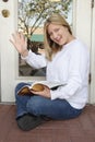 Cheerful woman employee waiting outdoors & waving