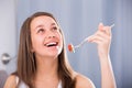 Cheerful woman is enjoying tasty green salad Royalty Free Stock Photo