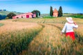 Cheerful woman enjoying the view in grain fields, Tuscany, Italy Royalty Free Stock Photo