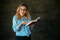 Cheerful woman excited about something after reading interesting book