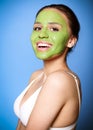 Cheerful woman with green mask