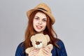 cheerful woman in a hat with a teddy bear gift toy Royalty Free Stock Photo