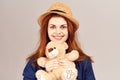 cheerful woman in a hat with a teddy bear gift toy Royalty Free Stock Photo