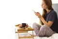 Cheerful Woman having breakfast in bed. Tea and pancakes with strawberry. Asian caucasian blogger woman smiling looking at camera Royalty Free Stock Photo