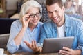 Cheerful woman and her grandson sitting at the table Royalty Free Stock Photo