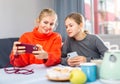 Girl with mother playing on phones Royalty Free Stock Photo