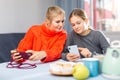 Girl with mother playing on phones Royalty Free Stock Photo