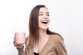 Cheerful woman holding coffee cup and laughing