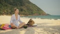 The cheerful woman in holding and eating slices of watermelon on tropical sand beach sea. Portrait attractive girl spend Royalty Free Stock Photo