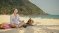 The cheerful woman in holding and eating slices of watermelon on tropical sand beach sea. Portrait attractive girl spend Royalty Free Stock Photo