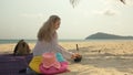 The cheerful woman in holding and eating slices of watermelon on tropical sand beach sea. Portrait attractive girl spend Royalty Free Stock Photo