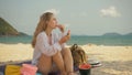 The cheerful woman in holding and eating slices of watermelon on tropical sand beach sea. Portrait attractive girl spend Royalty Free Stock Photo