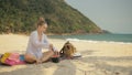 The cheerful woman in holding and eating slices of watermelon on tropical sand beach sea. Portrait attractive girl spend Royalty Free Stock Photo