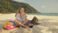 The cheerful woman in holding and eating slices of watermelon on tropical sand beach sea. Portrait attractive girl spend Royalty Free Stock Photo