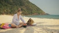 The cheerful woman in holding and eating slices of watermelon on tropical sand beach sea. Portrait attractive girl spend Royalty Free Stock Photo