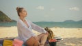 The cheerful woman in holding and eating slices of watermelon on tropical sand beach sea. Portrait attractive girl spend Royalty Free Stock Photo