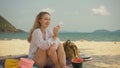 The cheerful woman in holding and eating slices of watermelon on tropical sand beach sea. Portrait attractive girl spend Royalty Free Stock Photo