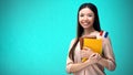 Cheerful woman holding French flag book, education abroad, learning language Royalty Free Stock Photo