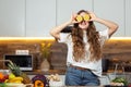 Healthy lifestyle concept, beautiful smiling woman Holding Fresh Lemon Slice In Front of her Eyes While Looking at the Royalty Free Stock Photo