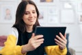 Cheerful Woman Holding PC Tablet at Home