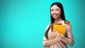 Cheerful woman holding Portuguese flag book, education abroad, learning language Royalty Free Stock Photo