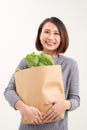 Cheerful woman holding a shopping bag full of groceries Royalty Free Stock Photo