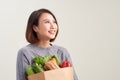 Cheerful woman holding a shopping bag full of groceries Royalty Free Stock Photo