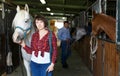 Cheerful woman horse farm worker Royalty Free Stock Photo