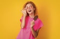 cheerful woman with icelolly ice cream isolated on yellow. woman with icelolly ice cream