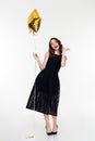 Cheerful woman with makeup in retro style holding golden balloon