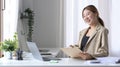 Cheerful woman office worker working in bright office. Royalty Free Stock Photo