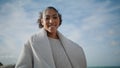 Cheerful woman open arms at cloudy sky bottom view. Happy african american pose Royalty Free Stock Photo