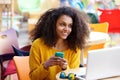 Cheerful woman at outdoor cafe with mobile phone Royalty Free Stock Photo