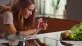 Woman photographing food on smartphone at kitchen. Blogger using mobile phone Royalty Free Stock Photo