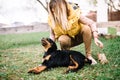 Cheerful woman playing with happy rottweiler puppy Royalty Free Stock Photo