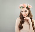 Cheerful woman portrait. Young model with clear skin, long healthy curly hair and flowers. Skincare and facial treatment concept Royalty Free Stock Photo