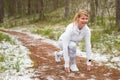 Woman preparing for a run outdoors in winter