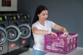 Woman in the public room to wash her cloths, self service commercial laundry and drying machine in a public room. Royalty Free Stock Photo